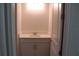 Charming powder room featuring a modern white vanity, quartz countertop and framed mirror at 4676 Hickory Oak Dr, Brooksville, FL 34601