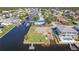 Aerial view of waterfront home with boat dock and canal access at 7332 Mako Dr, Hudson, FL 34667