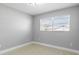 This bedroom has gray walls, tile floors, and a window with blinds at 7332 Mako Dr, Hudson, FL 34667