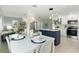 Open-concept dining area with a modern table setting, flowing into the stylish living room and well-equipped kitchen at 7332 Mako Dr, Hudson, FL 34667