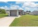 Charming single-story home featuring a well-maintained lawn and gray colored architectural details, including a two-car garage at 7332 Mako Dr, Hudson, FL 34667