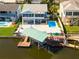 Aerial view of waterfront home with private pool, dock, and boat lift at 7637 Hatteras Dr, Hudson, FL 34667