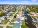 Wide aerial view of a waterfront community, showcasing numerous homes and waterways at 7637 Hatteras Dr, Hudson, FL 34667