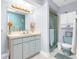 Bathroom with light blue vanity and a shower/tub combo at 7637 Hatteras Dr, Hudson, FL 34667