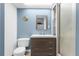 Clean bathroom with a vanity, toilet, and shower at 7637 Hatteras Dr, Hudson, FL 34667
