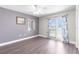 Bedroom with wood-look floors and sliding glass doors to a balcony at 7637 Hatteras Dr, Hudson, FL 34667
