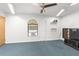 Bright bonus room with window, ceiling fan, and wall-mounted TV at 7637 Hatteras Dr, Hudson, FL 34667