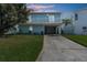 Light blue two-story house with balcony and garage at 7637 Hatteras Dr, Hudson, FL 34667
