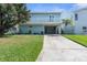 Light blue two-story house with balcony and garage at 7637 Hatteras Dr, Hudson, FL 34667