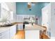 Bright kitchen with island, hardwood floors, and light-colored cabinetry at 7637 Hatteras Dr, Hudson, FL 34667
