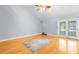 Spacious living area with hardwood floors and access to a patio at 7637 Hatteras Dr, Hudson, FL 34667
