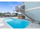 Private rectangular pool with wooden deck and hot tub at 7637 Hatteras Dr, Hudson, FL 34667