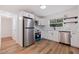 Modern kitchen with stainless steel appliances and white cabinets at 9413 N 16Th St, Tampa, FL 33612