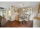 Dining area with a glass-top table, four chairs, and a built-in hutch at 12119 Sunny Glen Ln # H1, Hudson, FL 34669