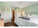 Bedroom with light green walls and leafy bedding at 12119 Sunny Glen Ln # H1, Hudson, FL 34669