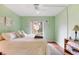 Bedroom with light green walls and leafy bedding at 12119 Sunny Glen Ln # H1, Hudson, FL 34669
