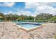 Community pool and spa area with brick pavers and ample space for relaxation at 12119 Sunny Glen Ln # H1, Hudson, FL 34669