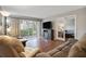 Living room with hardwood floors, comfortable sofas, and access to a patio at 12119 Sunny Glen Ln # H1, Hudson, FL 34669
