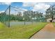 Community tennis court with green surface and chain-link fence at 12119 Sunny Glen Ln # H1, Hudson, FL 34669