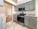 Gray kitchen cabinets and stainless steel appliances at 13626 Bryndlewood Ct, Hudson, FL 34669