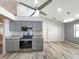 Open kitchen with gray cabinets and stainless steel appliances at 13626 Bryndlewood Ct, Hudson, FL 34669