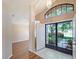 Inviting entryway with double doors and a view of the living room at 13626 Bryndlewood Ct, Hudson, FL 34669