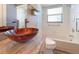 Updated bathroom with a vessel sink and a white bathtub at 13626 Bryndlewood Ct, Hudson, FL 34669