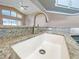 Modern kitchen sink and faucet with granite countertop at 13626 Bryndlewood Ct, Hudson, FL 34669