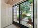 Inviting entryway with glass French doors opening to the front yard at 13626 Bryndlewood Ct, Hudson, FL 34669
