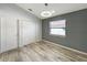 Bright bedroom with gray shiplap accent wall and hardwood floors at 13626 Bryndlewood Ct, Hudson, FL 34669