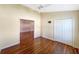 Spacious bedroom with hardwood floors and access to another room at 13626 Bryndlewood Ct, Hudson, FL 34669