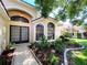 House exterior featuring a charming front porch and walkway at 13626 Bryndlewood Ct, Hudson, FL 34669