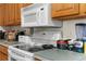 White appliances and wood cabinets highlight this kitchen at 3391 Lambert Ave, Spring Hill, FL 34608