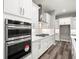 White shaker cabinets, stainless steel appliances, and white quartz countertops at 4676 Hickory Oak Dr, Brooksville, FL 34601