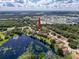 Aerial view showing a home community near a lake and other houses at 35316 Whispering Pines Dr, Zephyrhills, FL 33541