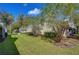 Landscaped backyard with a view of neighboring homes and trees at 3605 Kings Rd # 102, Palm Harbor, FL 34685