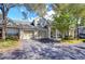 Tan two-story townhome with a two-car garage and well-manicured landscaping at 3605 Kings Rd # 102, Palm Harbor, FL 34685