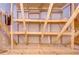 Unfinished storage area with wood framing and shelving at 3605 Kings Rd # 102, Palm Harbor, FL 34685