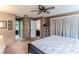 Comfortable bedroom with ensuite bathroom and access to hallway at 7076 Pond View Ct, Spring Hill, FL 34606