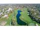 Aerial view showing a golf course with a water feature at 7076 Pond View Ct, Spring Hill, FL 34606