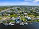 Aerial view of waterfront homes and properties with boats and lush landscaping at 4359 Tahiti Dr, Hernando Beach, FL 34607