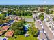 Aerial view of community, highlighting building and tennis court at 1127 King Arthur Ct # 305, Dunedin, FL 34698