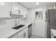 Modern kitchen with white cabinets, stainless steel appliances, and quartz countertops at 1127 King Arthur Ct # 305, Dunedin, FL 34698