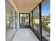 Screened porch with tiled floor and view of backyard at 1127 King Arthur Ct # 305, Dunedin, FL 34698