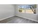 Bright bedroom with gray vinyl flooring and large window at 1127 King Arthur Ct # 305, Dunedin, FL 34698