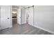 Bedroom with gray vinyl flooring and barn door to bathroom at 1127 King Arthur Ct # 305, Dunedin, FL 34698
