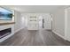 Open living room features a kitchen, fireplace, and gray vinyl flooring at 1127 King Arthur Ct # 305, Dunedin, FL 34698