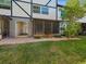 Back patio with stone pavers and small lawn area at 1127 King Arthur Ct # 305, Dunedin, FL 34698