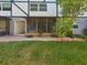 Back patio with stone pavers and small lawn area at 1127 King Arthur Ct # 305, Dunedin, FL 34698