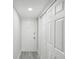 Bright condo entryway with white doors and gray floor at 1127 King Arthur Ct # 305, Dunedin, FL 34698